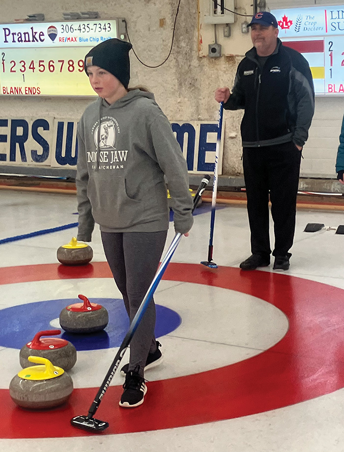 Cory Barkley helping coach young curlers.”></a><br />
<p class=